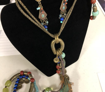 Jewelry set - necklace, earrings, and three bracelets, beaded and with feathers, for the silent auction.