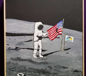 One-of-a-kind moon landing painting with a KMA flag added to the surface of the moon behind an astronaut and the American flag for the live auction.