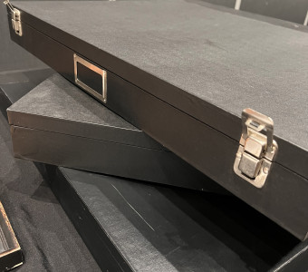 Stack of three large archival document cases with silver latches.