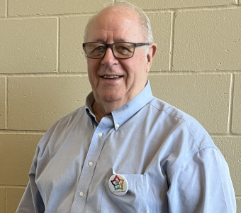 Image of Ray Rothgeb wearing glasses and a blue button up shirt.