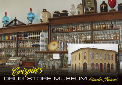 An image of two wooden cabinets and a counter display case holding glass medicine bottles.  An imposed photo of the exterior of a post-rock building with arched doors and windows.  Text at the bottom says "Crispin's Drug Store Museum, Lincoln, Kansas"