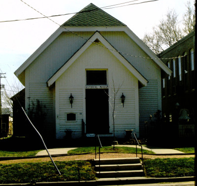 Image of the white pitched roof Peabody Historical Society with sconces flanking the door and "Historical Museum" above the door.