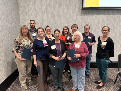 2023 KMA Conference Scholarship recipients stand in the front of the general session room and are recognized.