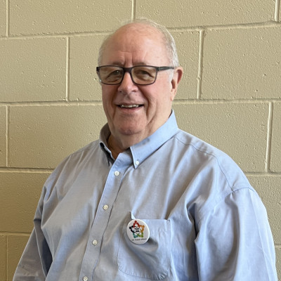 Image of Ray Rothgeb wearing glasses and a blue button up shirt.