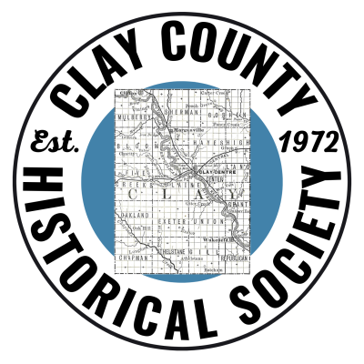 Logo with "Clay County Historical Society Est. 1972" in a circle with a blue circle inside overlaid with a map of Clay County. 