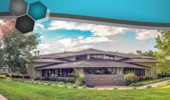 Exterior building view with sign "Museum of Deaf History, Arts & Culture" and green grass in front.
