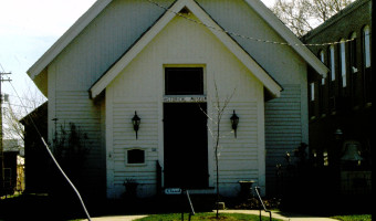 Image of the white pitched roof Peabody Historical Society with sconces flanking the door and "Historical Museum" above the door.