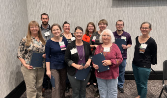 2023 KMA Conference Scholarship recipients stand in the front of the general session room and are recognized.