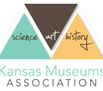Kansas Museums Association logo with a teal triangle with the word science inside, an inverted brown triangle with the word art inside, and a sunflower yellow triangle with the word history inside.  A stylized white M runs between the triangles, and the words Kansas Museums Association appear below.