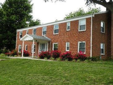 Image of two storey red brick St. Catherine Hall at the Sofia Center in Atchison with small white portico over door.