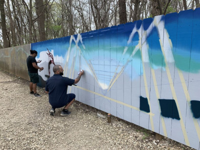 In-progress shot of the KCAIC Mural & Public Art Roster IT-RA artists Isaac Tapia and Rodrigo Alvarez called “Serene Flight” on the Lehigh Portland Trails located in Allen County, Kansas. This project was funded by KCAIC through Thrive Allen County in 2021.
